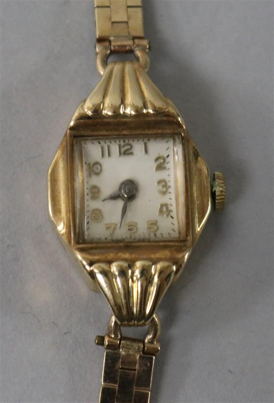 A ladys 9ct gold manual wind wrist watch on a 9ct gold bracelet.